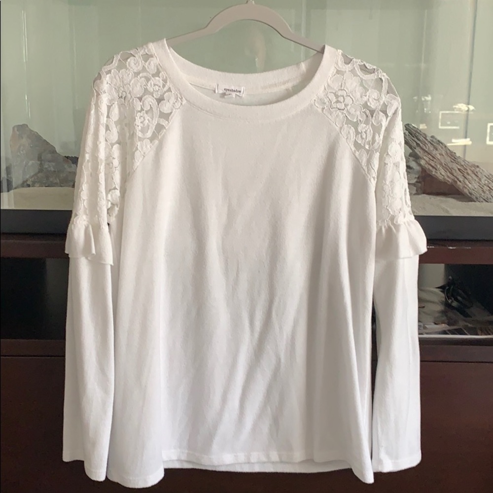 White sweater with lace around the shoulders